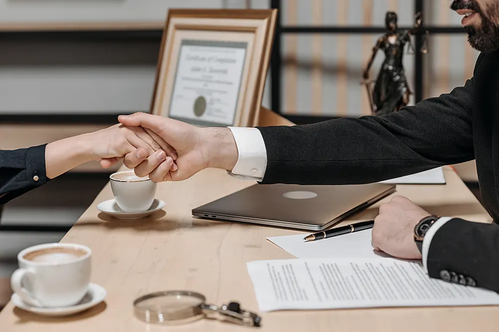 An agreement signed across a desk